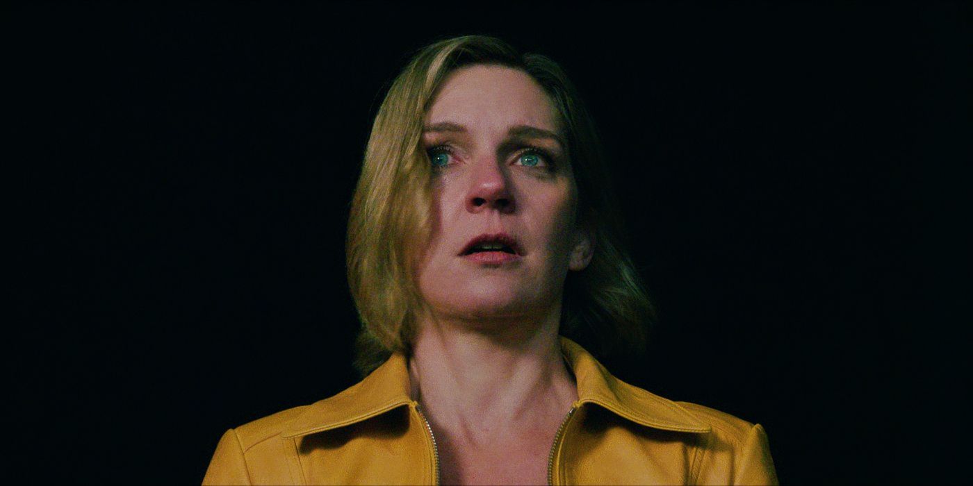 Close-up of Carol, face emotional and human, looking up toward something off-camera